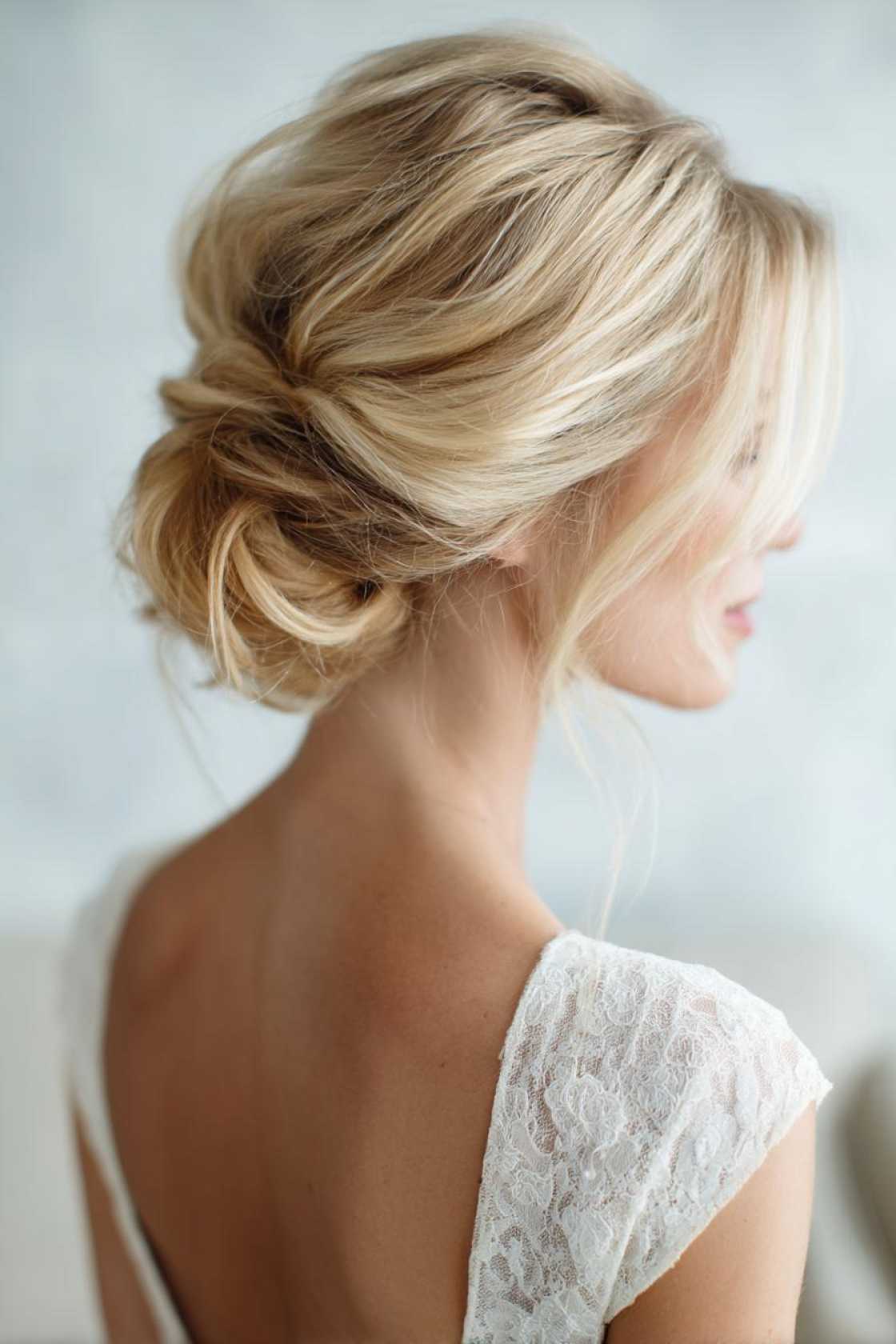 15+ Show-Stopping Homecoming Hairstyles to Wow This Year (Updos, Curls & More!) - 12. Low Bun with Face-Framing Pieces