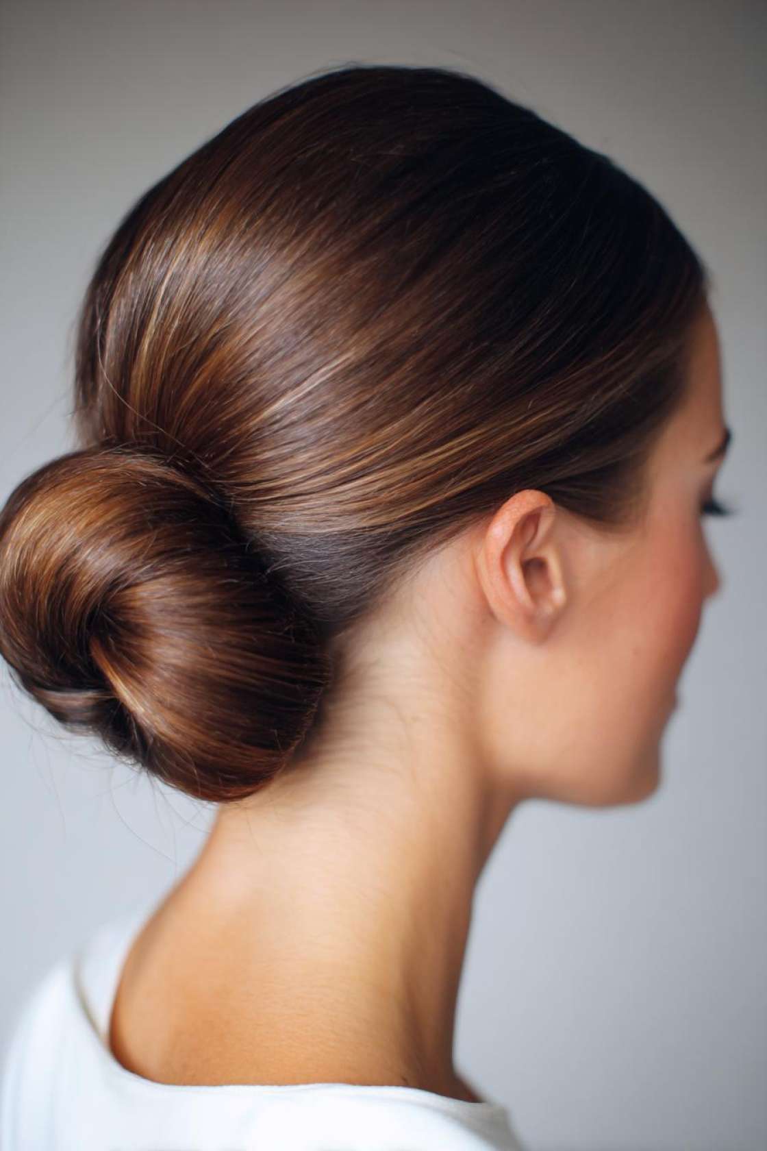 15+ Stunning Ways to Style Dark Brown Hair (From Sleek to Voluminous). - 2. Sleek Bun