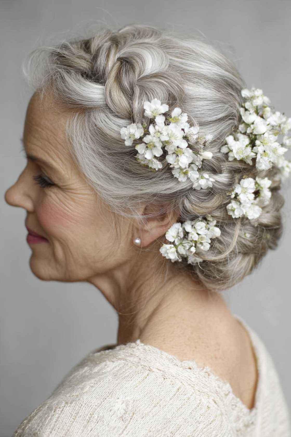 Wedding Day Glam: 20+ Stunning Hairstyle Inspirations for the Mother of the Groom. - 6. Braided Updo with Flowers