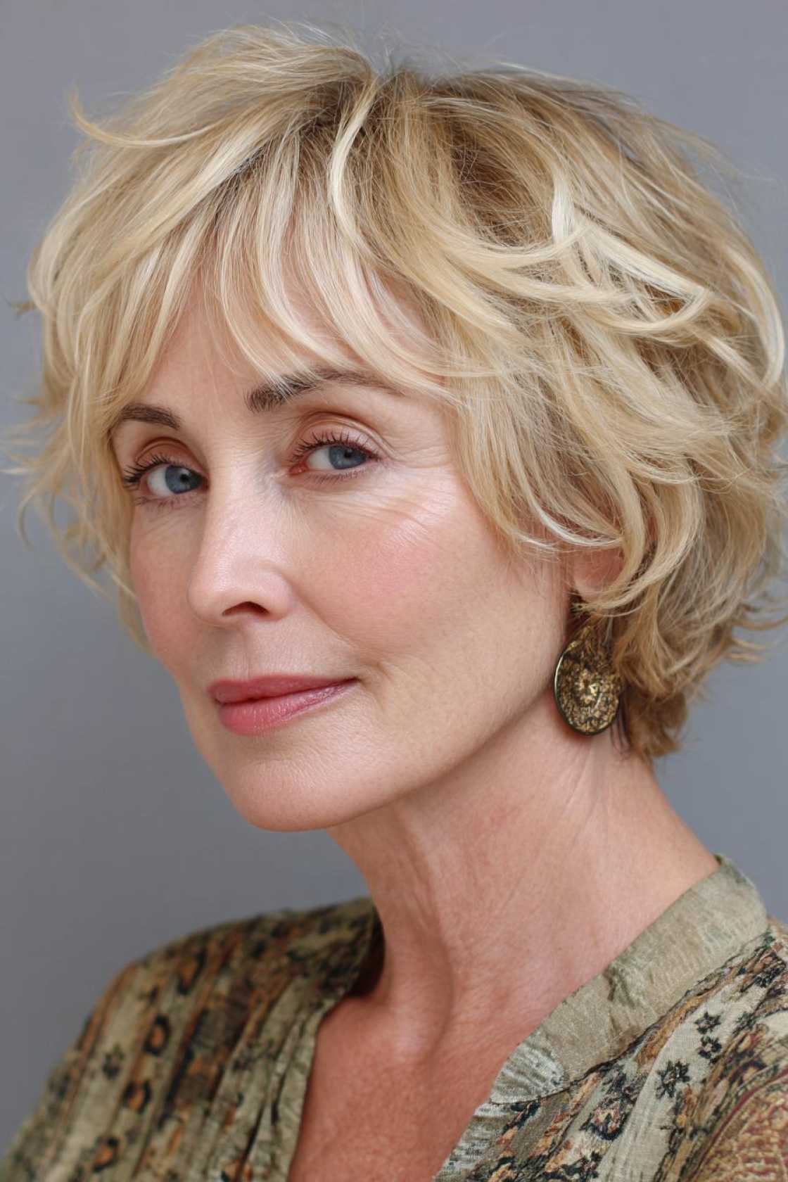 Ageless Curls: 20+ Chic & Modern Curly Hairstyle Ideas for Women Over 50. - 22. The Modern Shag with Bangs