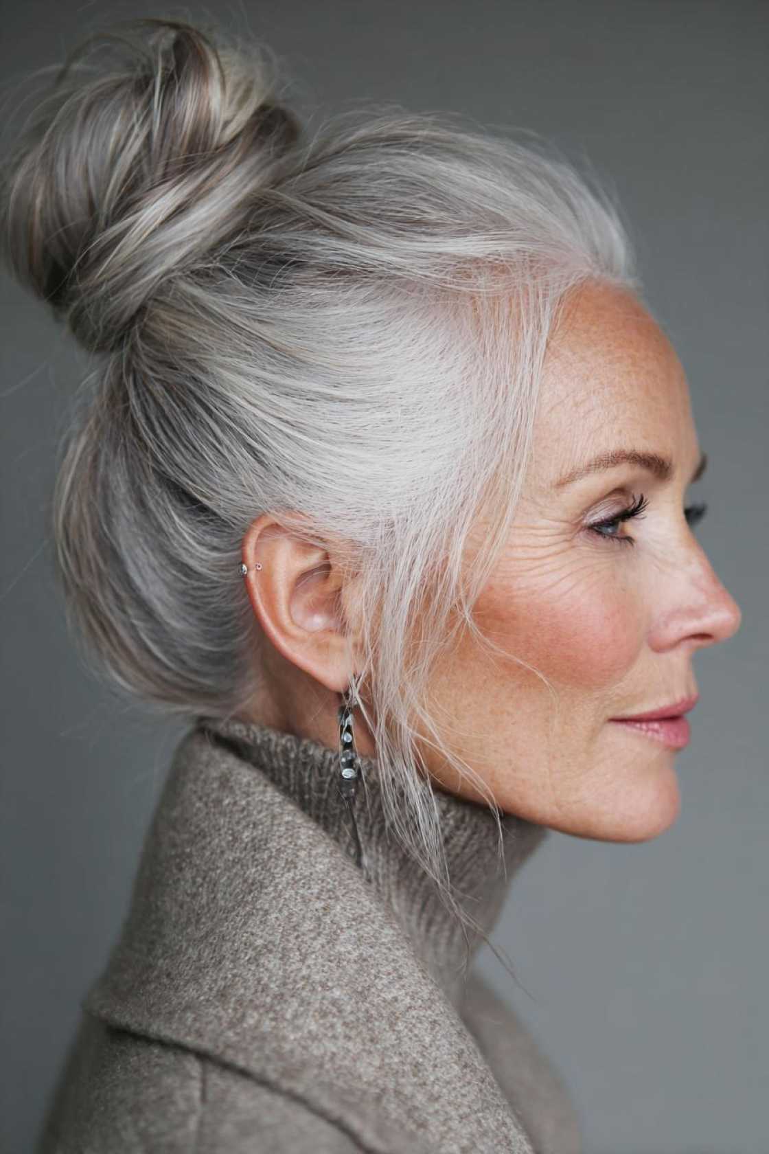 Long Hair, Don't Care (About Age!): 20+ Chic Long Hairstyle Ideas for Women Over 50. - 4. High Bun with Face-Framing Pieces