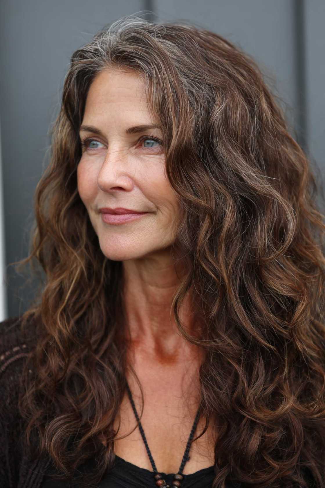 Long Hair, Don't Care (About Age!): 20+ Chic Long Hairstyle Ideas for Women Over 50. - 16. Loose Curls with Middle Part