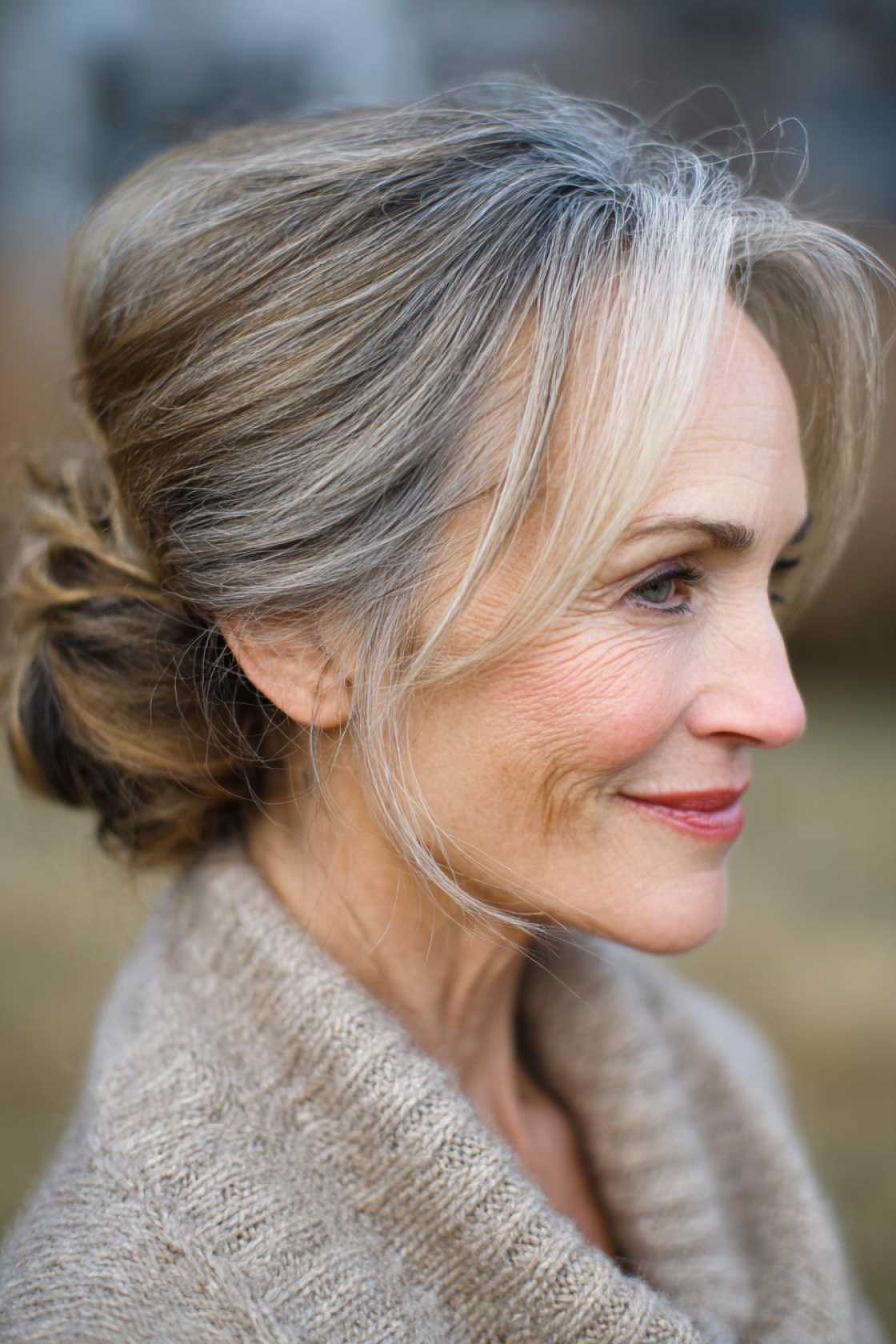 Long Hair, Don't Care (About Age!): 20+ Chic Long Hairstyle Ideas for Women Over 50. - 13. Low Bun with Wispy Strands