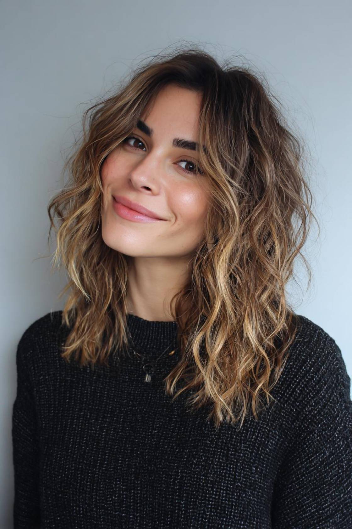 From Beanie-Proof Braids to Sleek Buns: 13+ Winter Hair Ideas to Try - 8. The Textured Wavy Lob